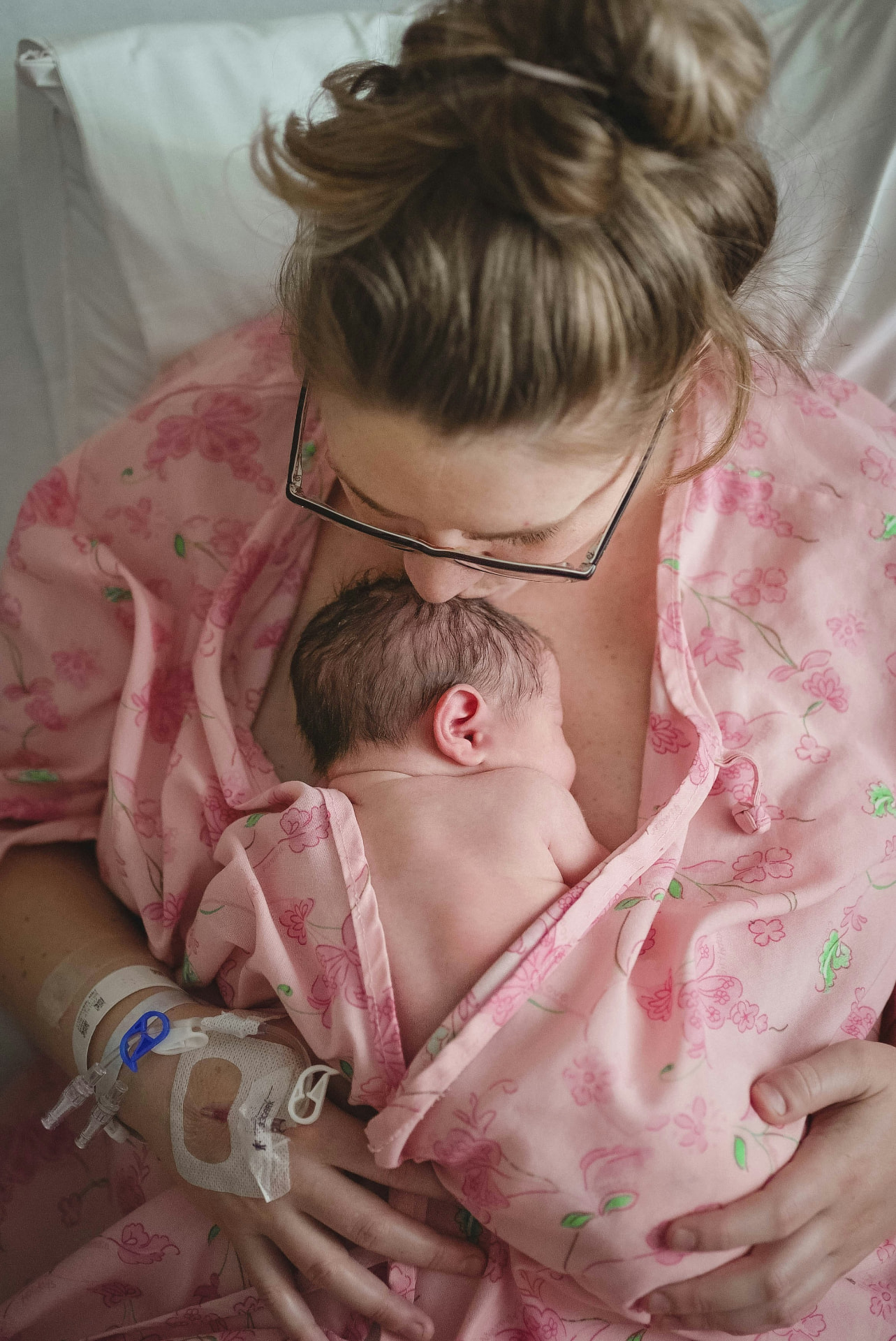 A mother holding her baby close